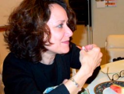 Carol Kaplan sitting at kitchen table with sweet smile