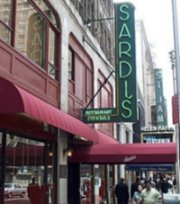 The tall green Sardi's marquee looms ahead, a canopy stretched out below it.