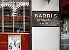 Beneath the canopy we see a plaque on the wall that says Sardi's Restaurant and Grill.