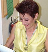 Pic: Deb Girdler smiling, studying her lines.