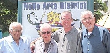 Norman Martin, Fred Ebb, Steve Schalchlin & Jim Brochu standing in front of the NoHo Arts District sign