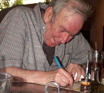 Fred Ebb signs Jimmy's Playbills. He's so cute sticking his tongue out when he writes.