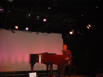 Steve Schalchlin singing at the piano.