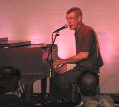 Steve Schalchlin singing at the piano.